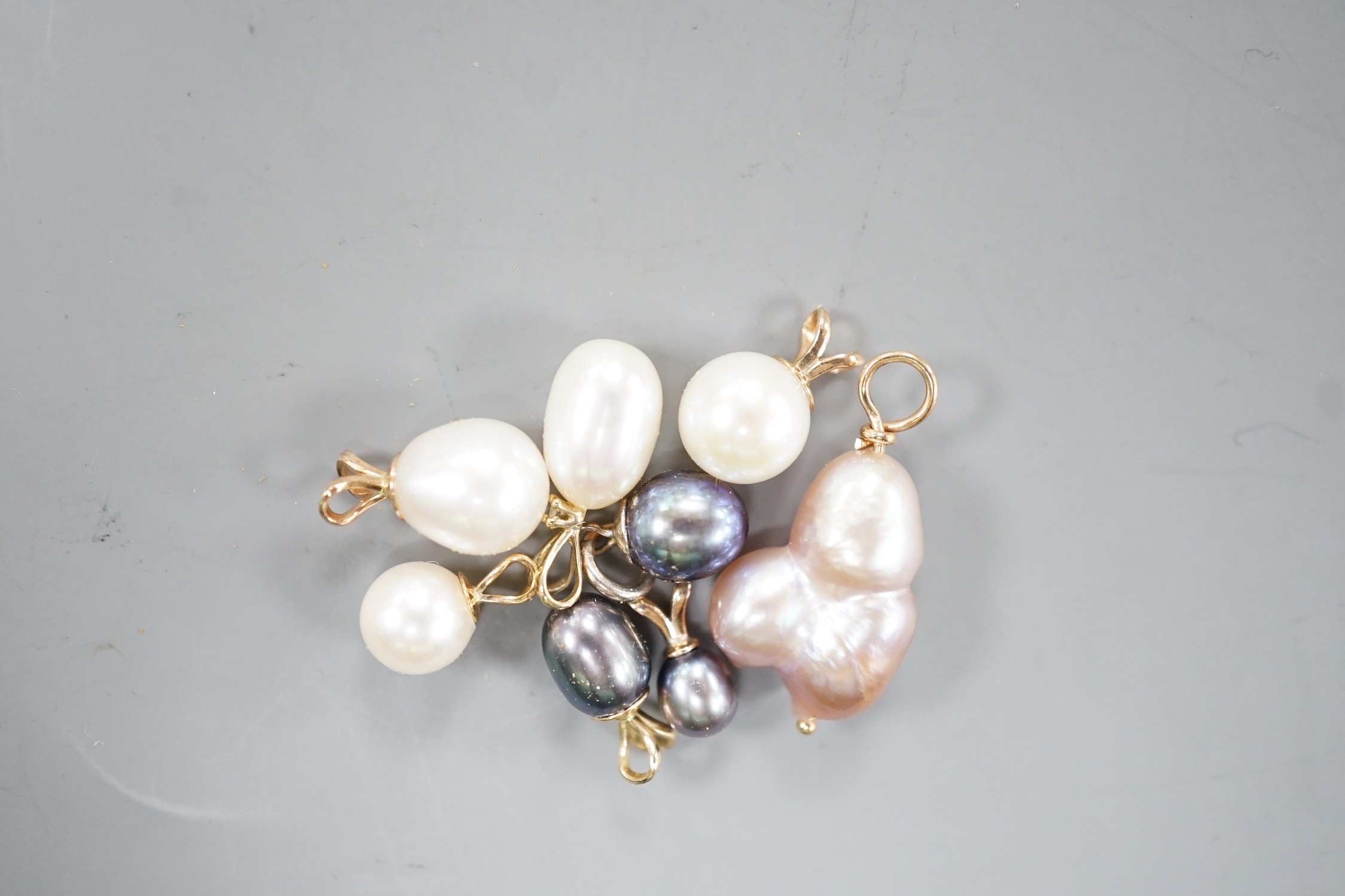 Seven assorted modern yellow metal mounted cultured pearl pendants and a similar white metal mounted pendant, largest 23mm.
